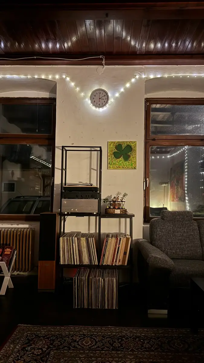 The lounge at night with fairy lights and a vinyl collection